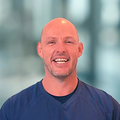 Dr. Luke Lotriet smiling with a blue shirt